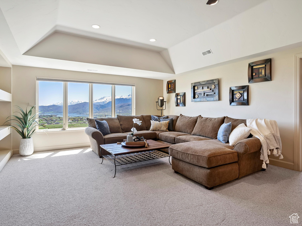 Living room featuring a tray ceiling, carpet floors, a mountain view, and recessed lighting