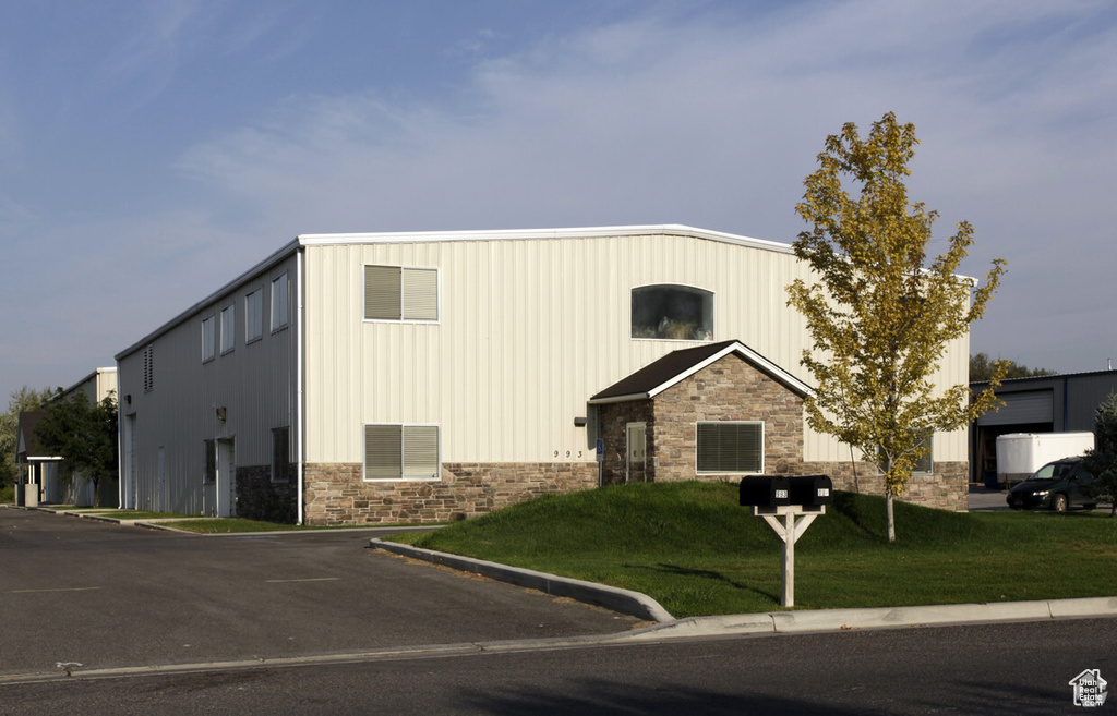 View of property featuring uncovered parking