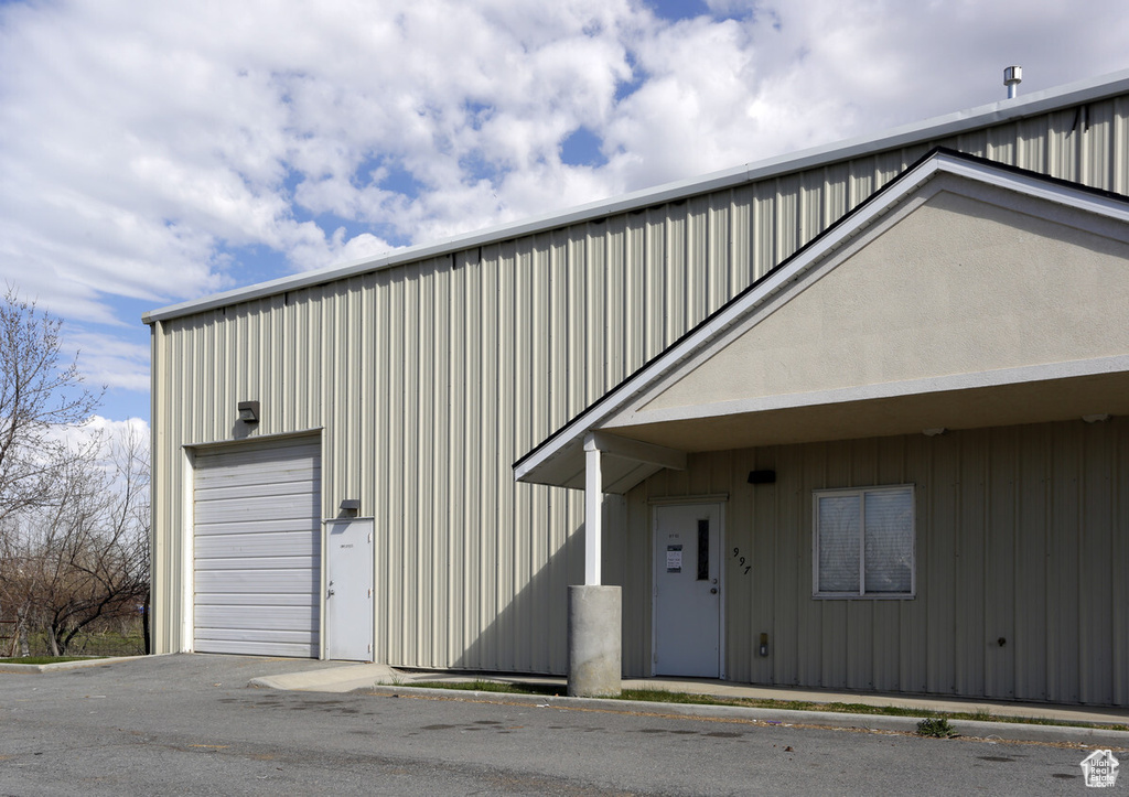 View of front facade featuring board and batten siding and an outdoor structure