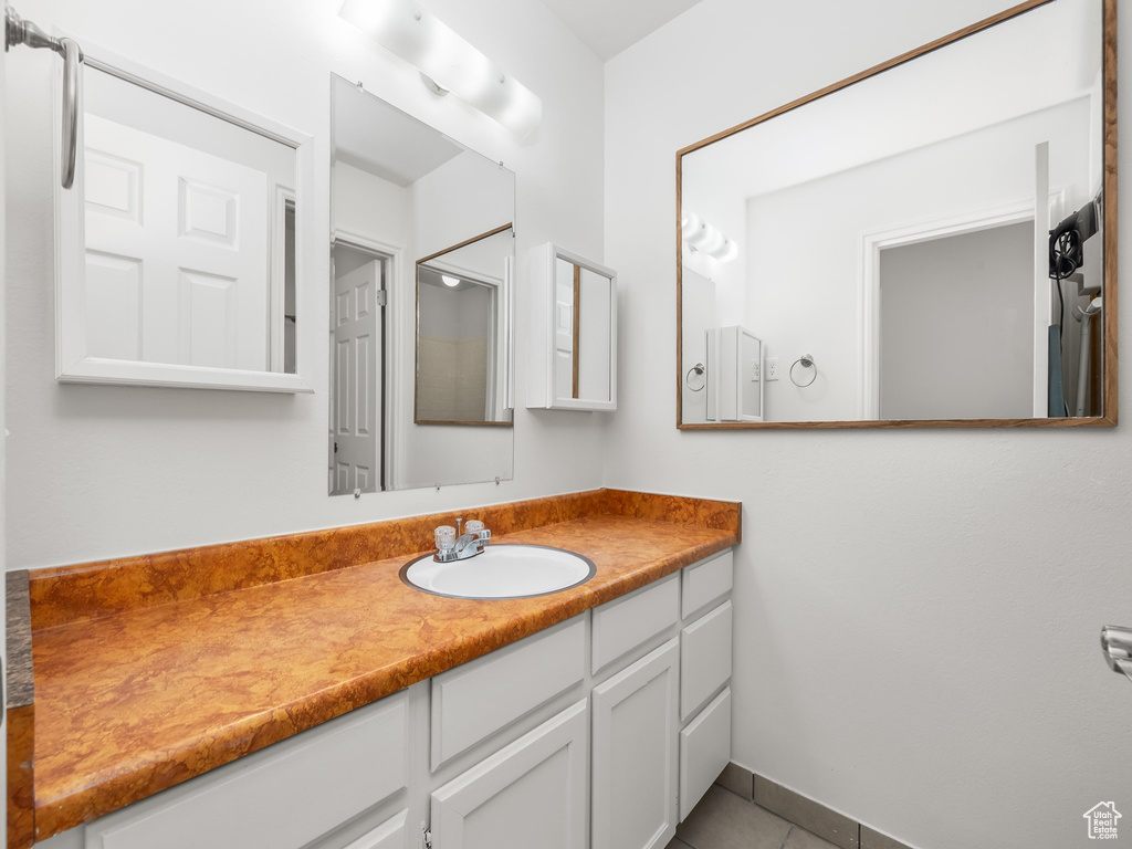Bathroom featuring vanity and tile patterned floors