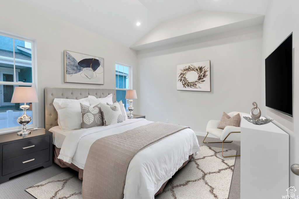 Bedroom with lofted ceiling and carpet