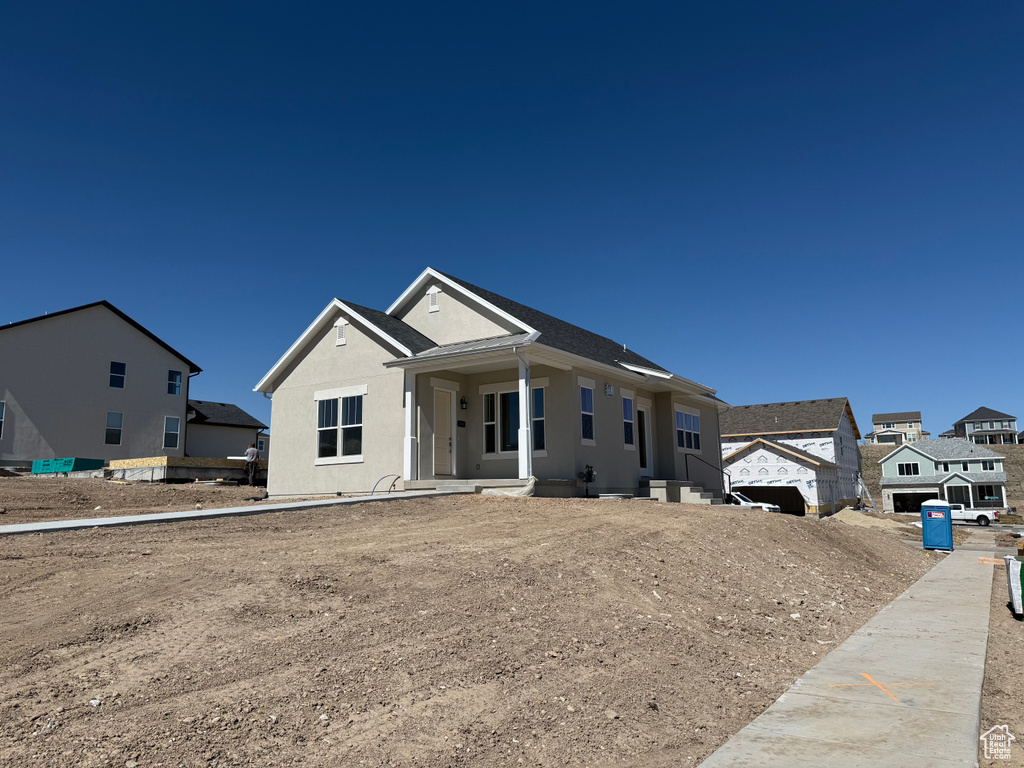 View of front of house featuring a porch and stucco siding
