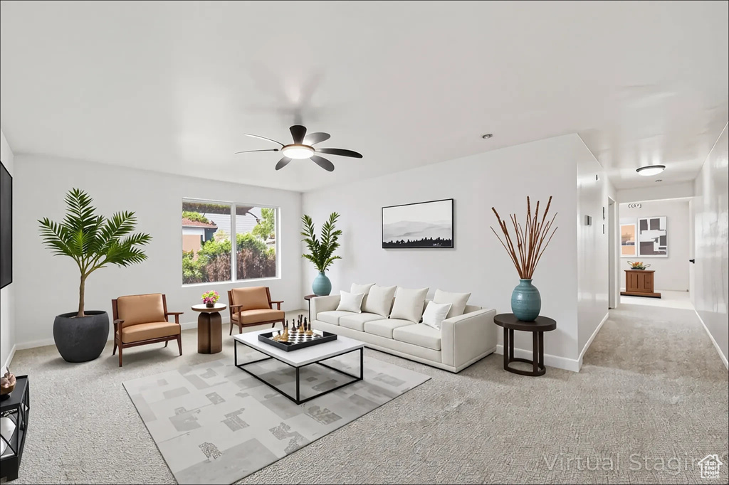 Living area featuring carpet flooring and a ceiling fan