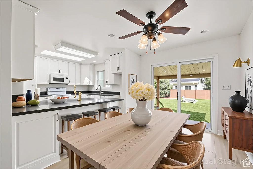 Dining space with a ceiling fan and recessed lighting