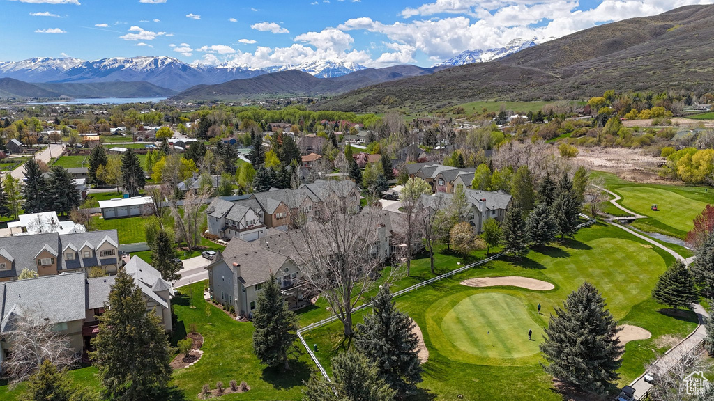 Birds eye view of property featuring view of golf course, a residential view, and a mountain view