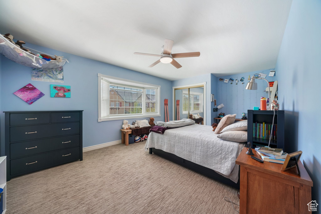 Bedroom featuring a closet, carpet flooring, baseboards, and ceiling fan