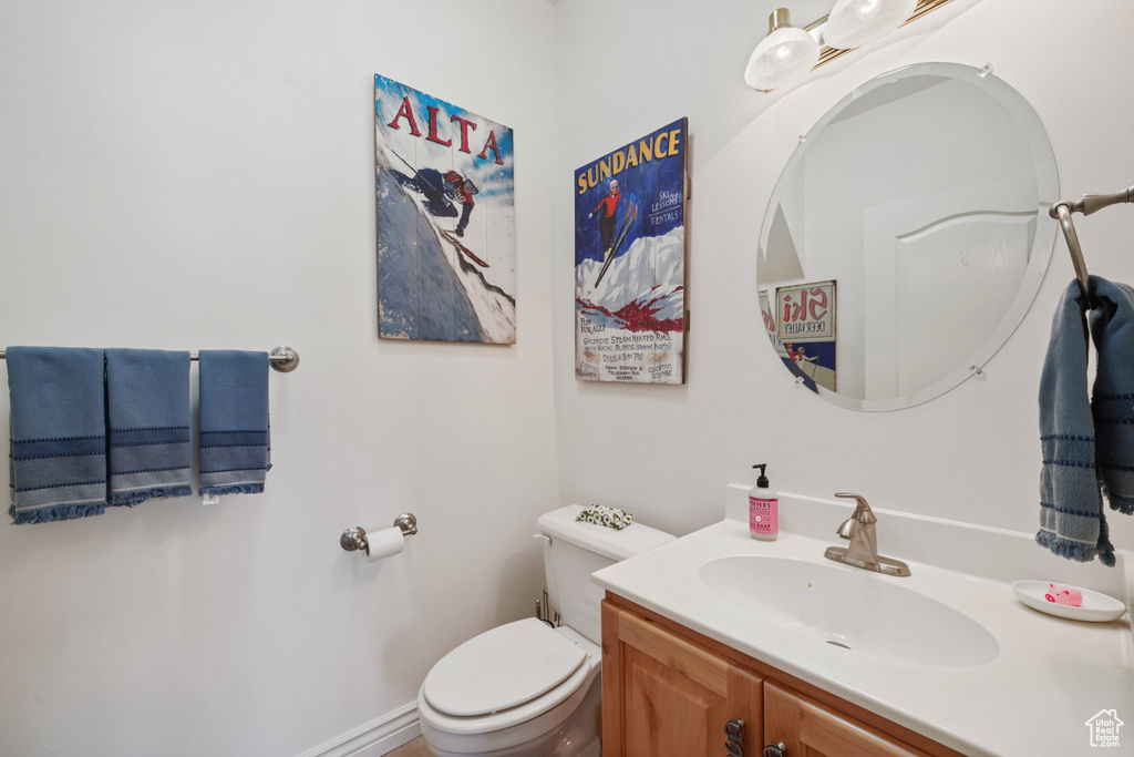 Half bath featuring toilet and vanity