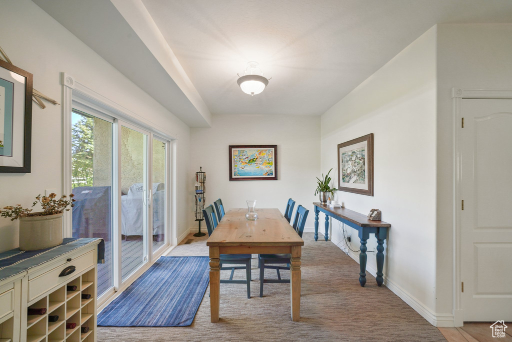 Dining room with baseboards and light carpet