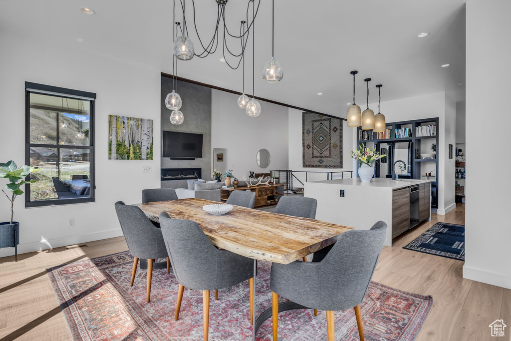 Dining area featuring light wood finished floors, baseboards, and recessed lighting