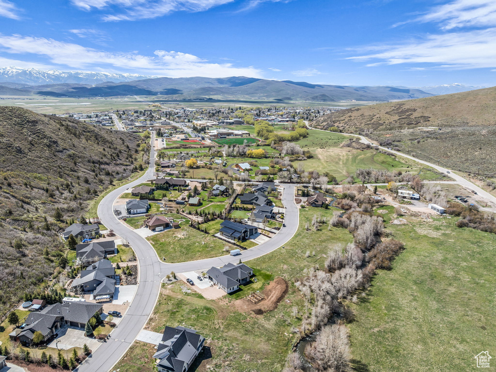 View of property location featuring a mountain backdrop and nearby suburban area