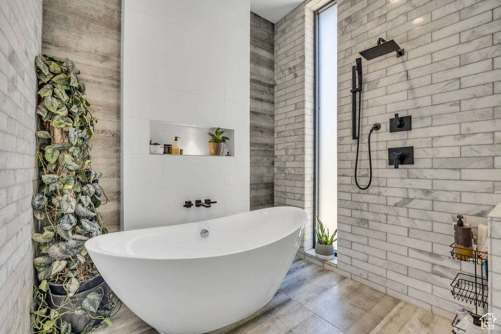 Full bathroom with tiled shower and a freestanding tub