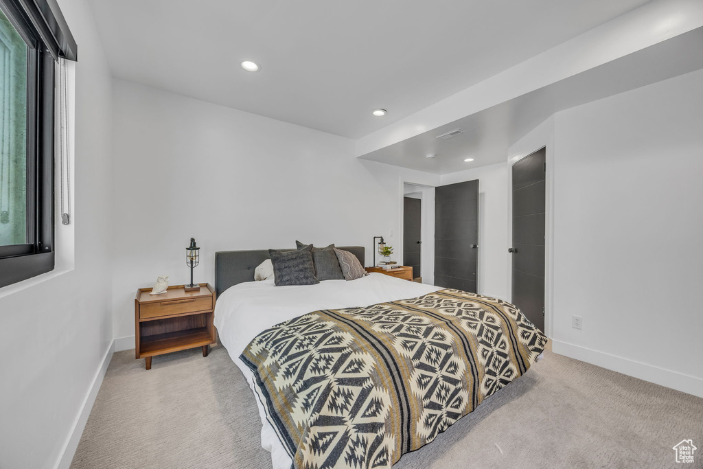 Carpeted bedroom with baseboards and recessed lighting
