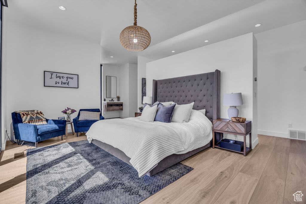 Bedroom with wood finished floors, recessed lighting, and baseboards