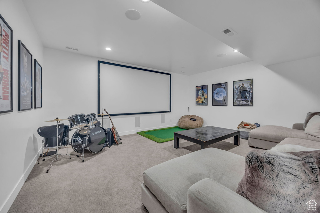 Carpeted home theater room with baseboards and recessed lighting