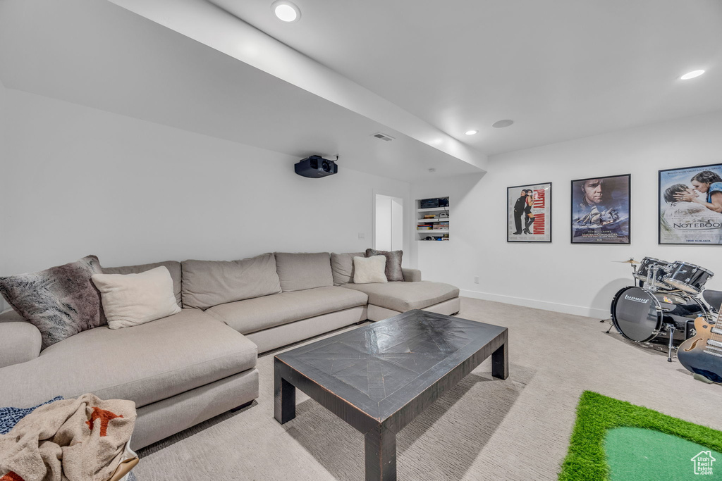 Living area featuring recessed lighting, light colored carpet, and baseboards