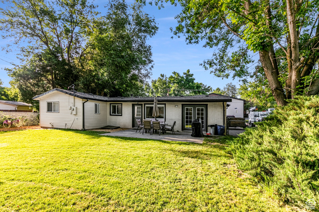 Back of house with a patio, a gate, french doors, fence, and a yard
