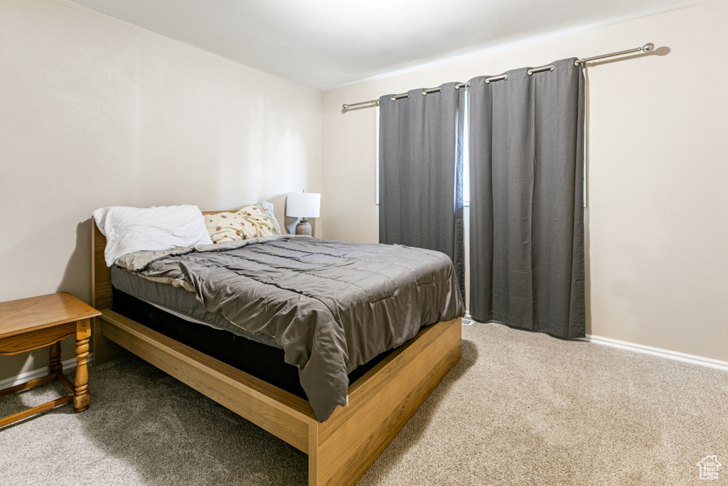 Bedroom with baseboards and carpet floors