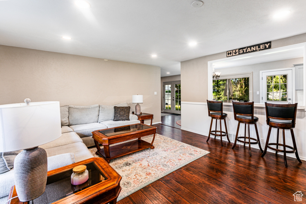 Living area featuring hardwood / wood-style floors, recessed lighting, and a wainscoted wall