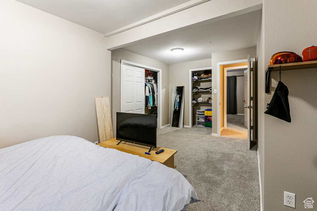 Carpeted bedroom featuring a closet