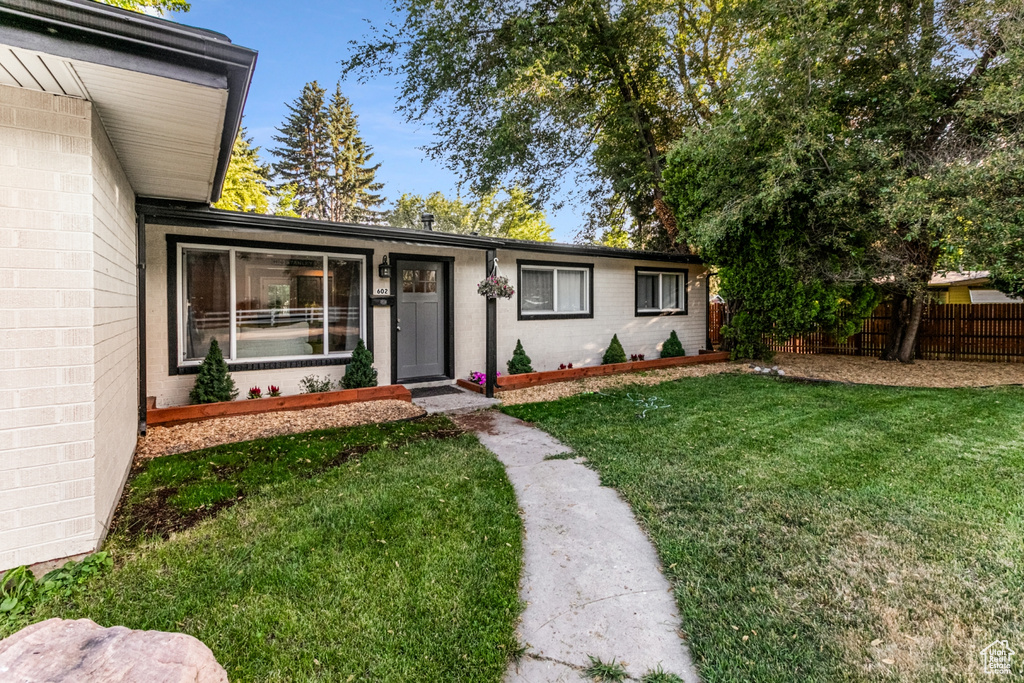 Exterior space featuring a lawn and fence