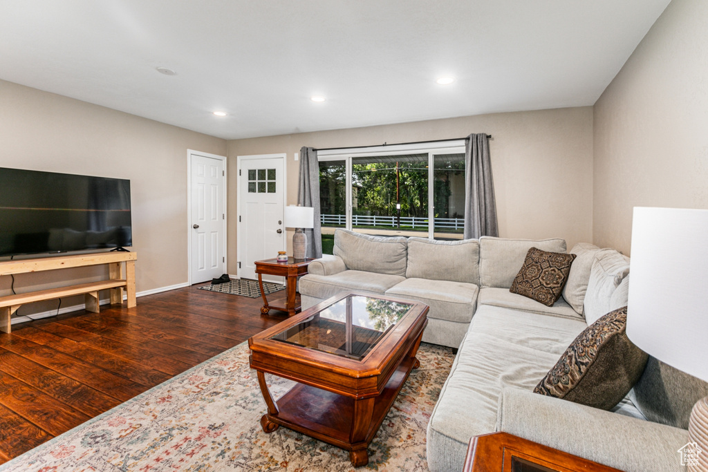 Living room featuring wood finished floors, baseboards, and recessed lighting