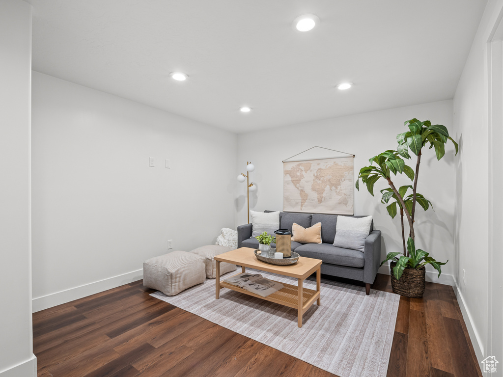 Living area featuring baseboards, recessed lighting, and wood finished floors