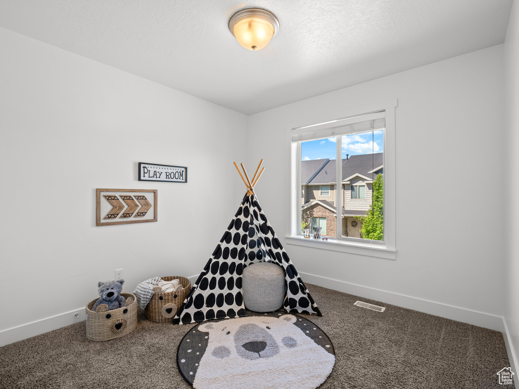 Recreation room with visible vents, baseboards, and carpet floors