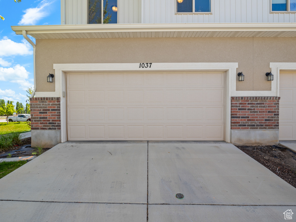 Garage featuring concrete driveway
