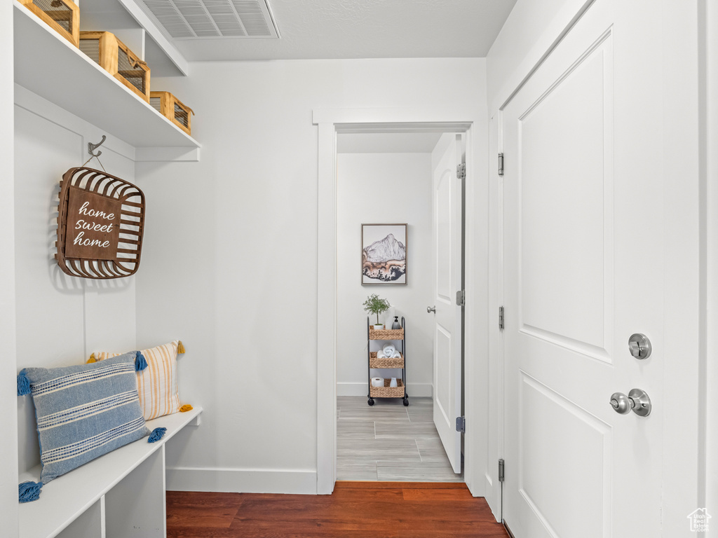 Mudroom featuring visible vents, wood finished floors, and baseboards