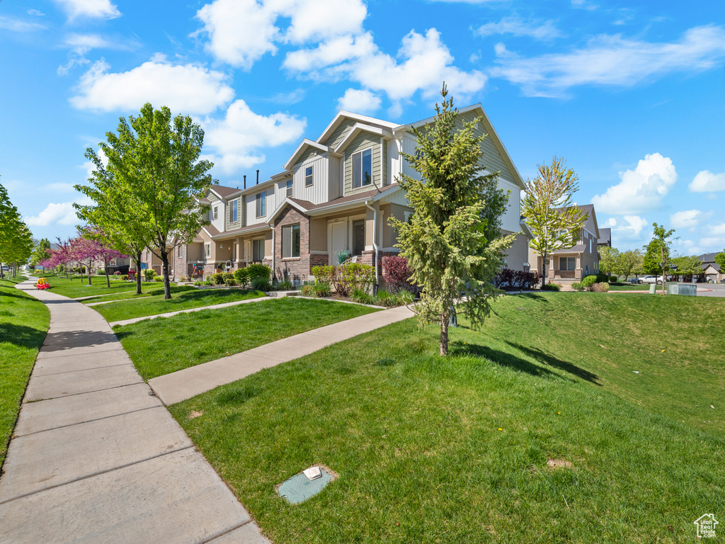 View of front of home with a residential view and a front yard