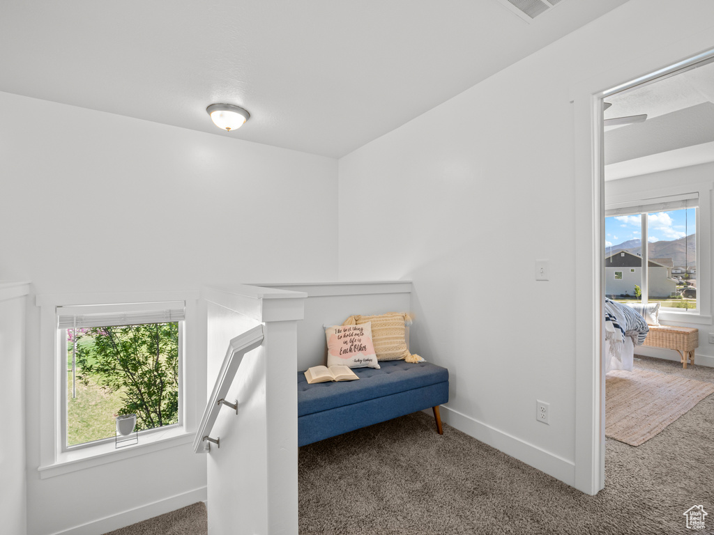 Sitting room with baseboards and carpet