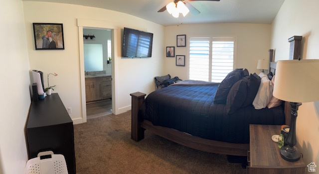 Bedroom with carpet floors, ceiling fan, baseboards, and ensuite bath