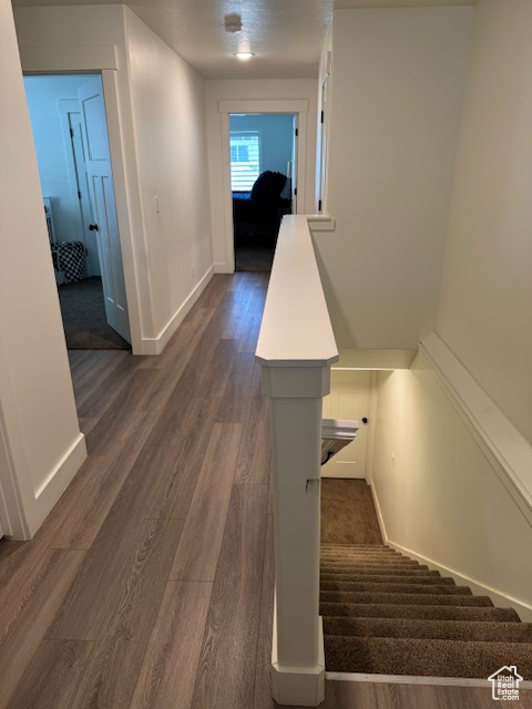 Stairs with baseboards and wood finished floors