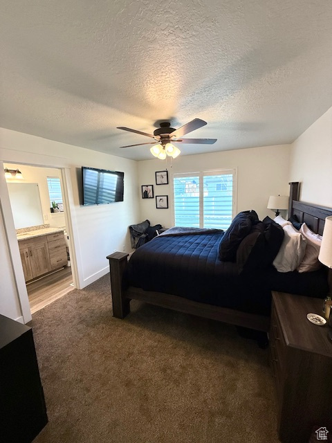Bedroom featuring dark colored carpet, a ceiling fan, a textured ceiling, and ensuite bathroom