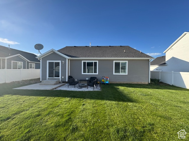Back of house with a lawn, a fenced backyard, and a patio area