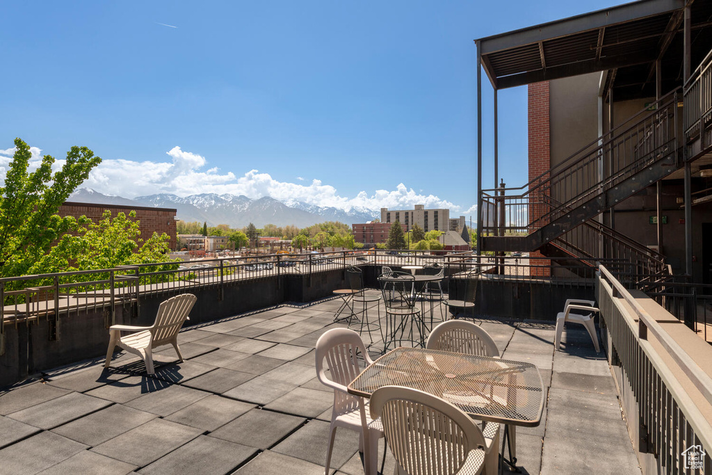 View of patio with outdoor dining space and a mountain view