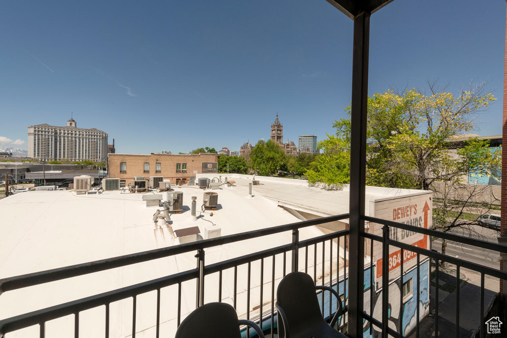 Balcony featuring central AC unit and a city view