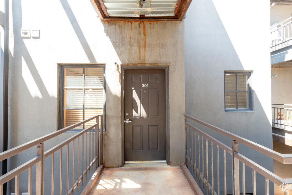 Entrance to property with stucco siding