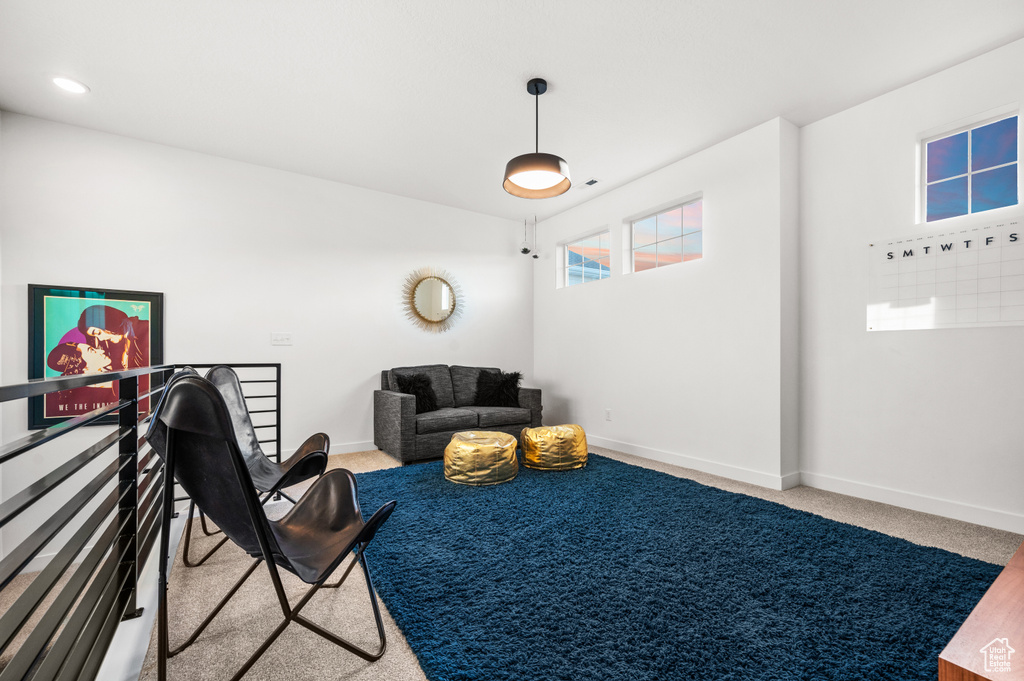 Sitting room featuring light carpet and baseboards