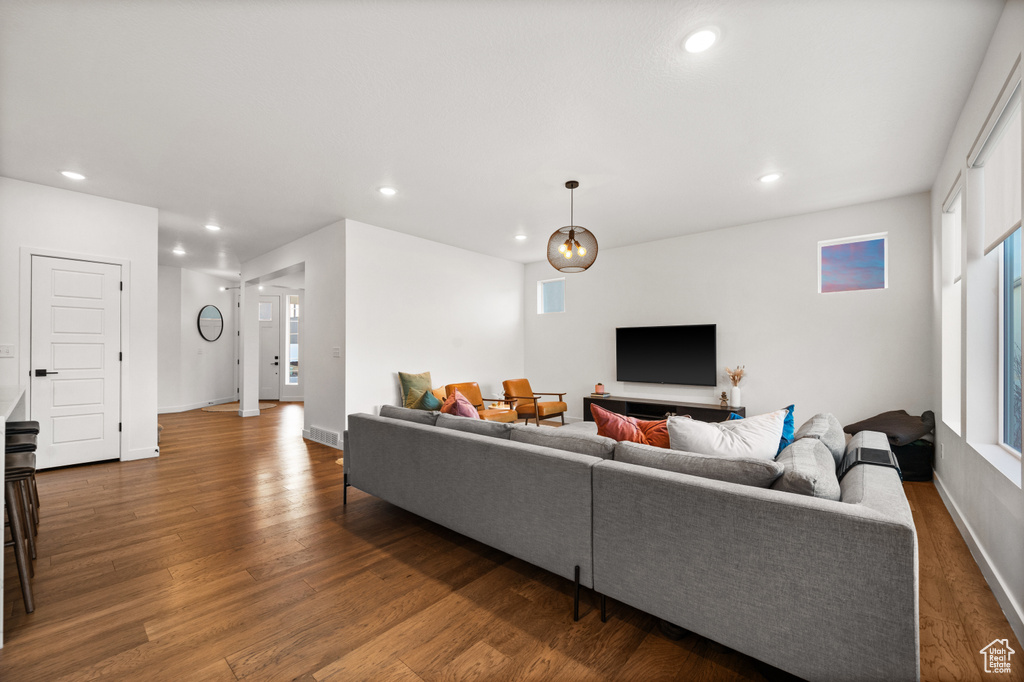 Living area featuring wood finished floors, baseboards, and recessed lighting
