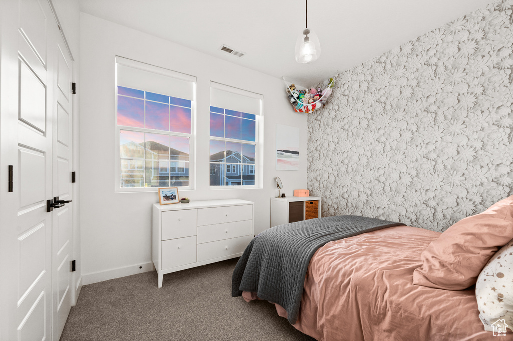 Bedroom featuring baseboards, visible vents, and carpet floors