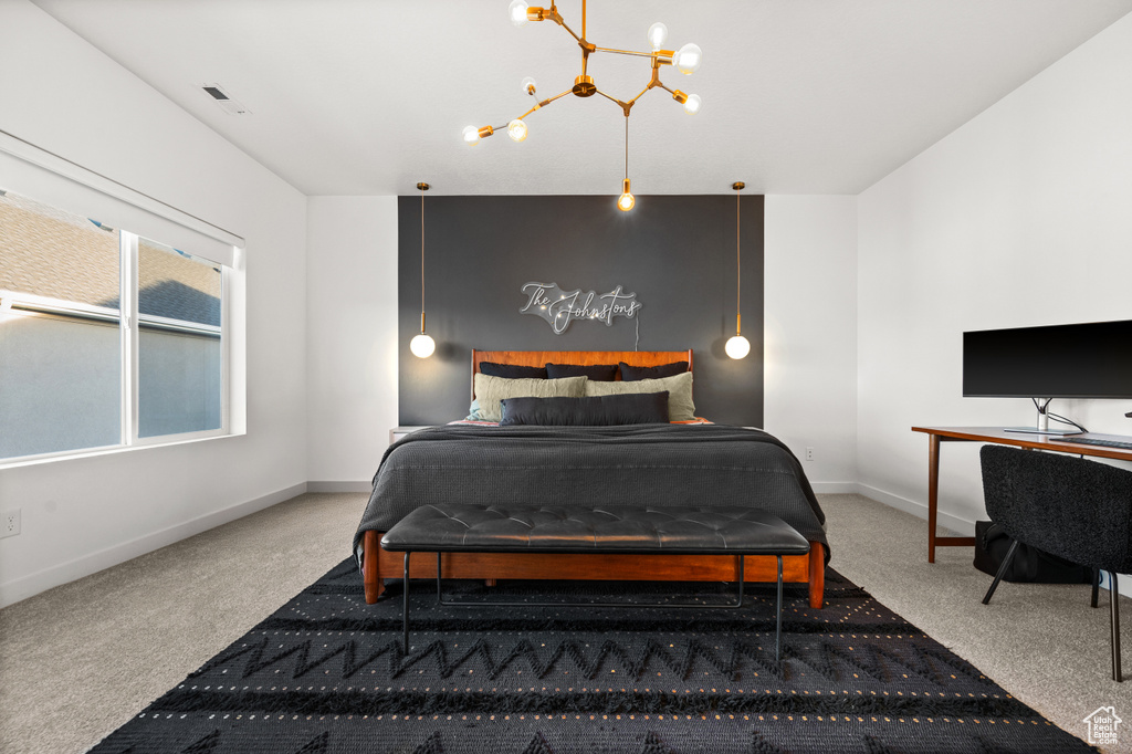 Bedroom featuring carpet, a chandelier, and baseboards