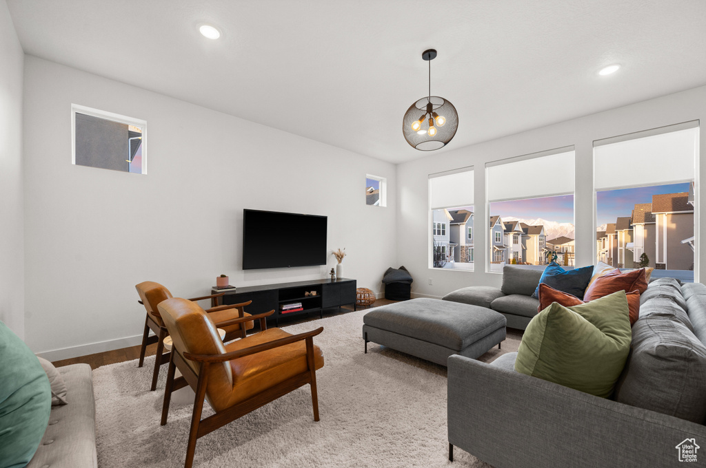 Living room featuring wood finished floors, baseboards, and recessed lighting