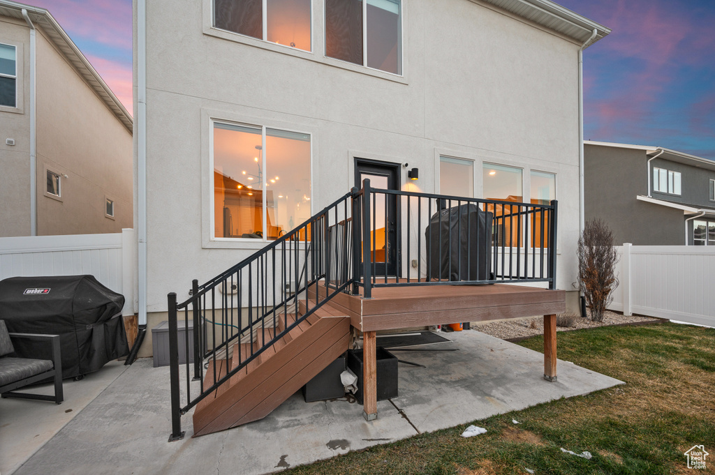 Back of property with a patio, stucco siding, and fence