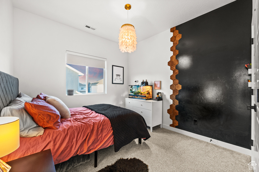 Bedroom with carpet floors and visible vents