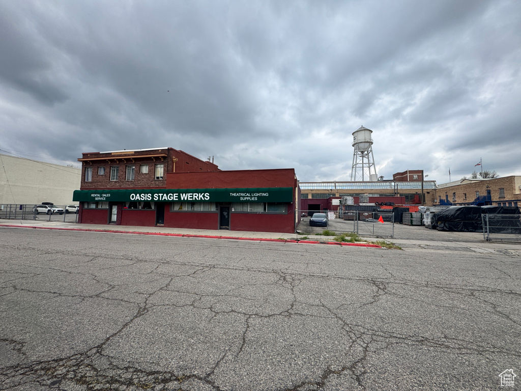 View of building exterior featuring uncovered parking