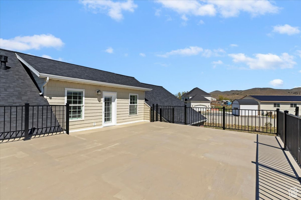 View of patio featuring a residential view, a mountain view, and fence