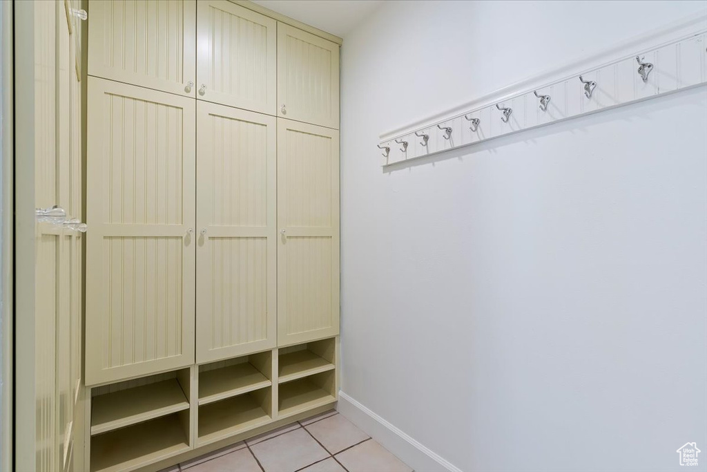Mudroom with light tile patterned floors and baseboards