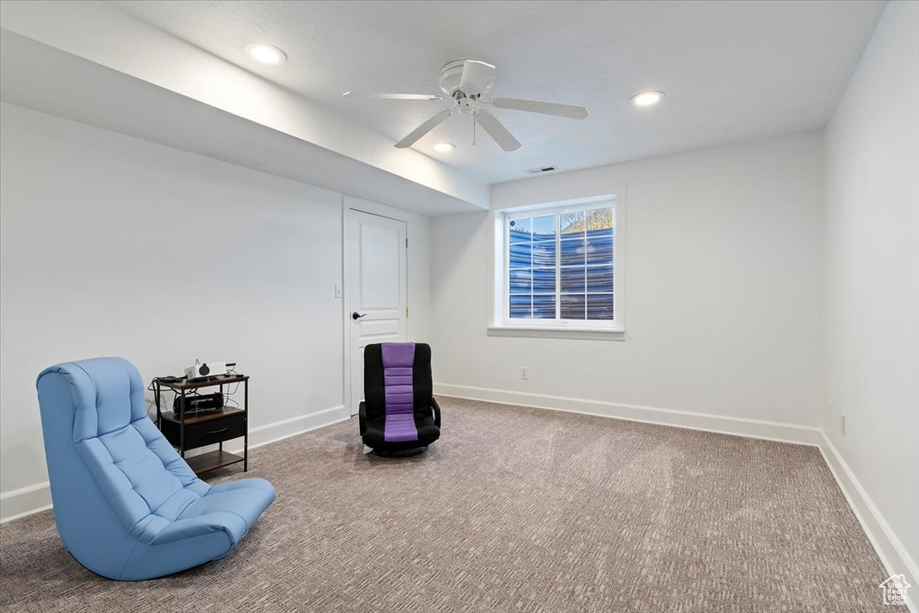 Living area with carpet, visible vents, and baseboards