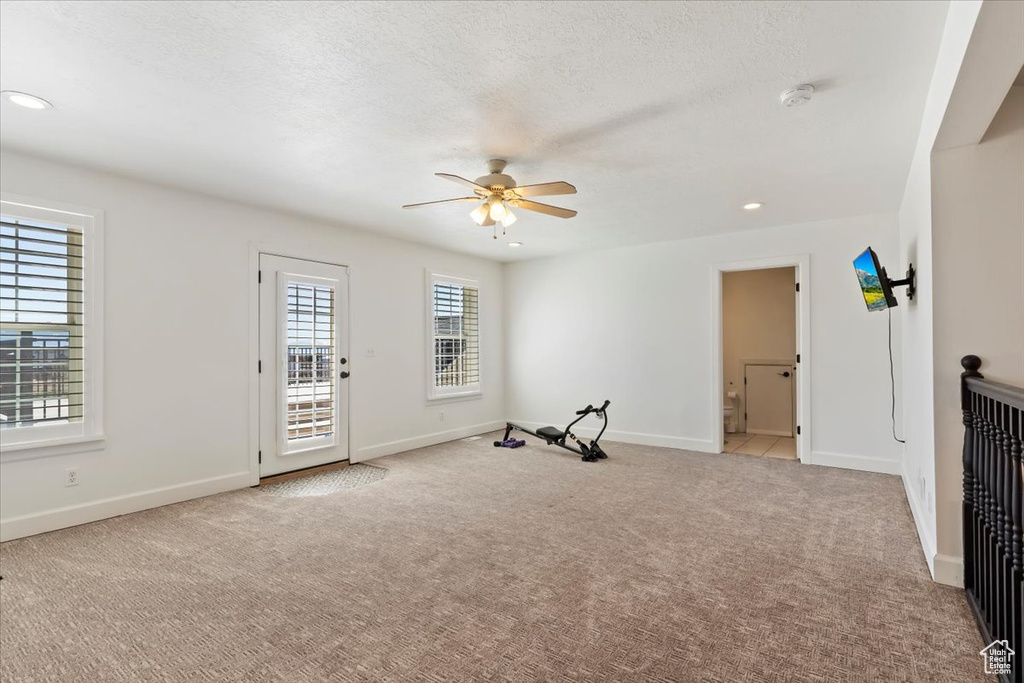 Interior space with recessed lighting, baseboards, ceiling fan, and carpet floors